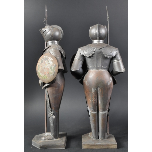 106 - A pair of vintage 20th Century pressed metal Maltese Knight figurines. The armoured figures with pol... 