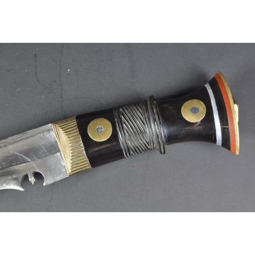 11 - A vintage Nepalese / Gurkha Regiment Kukri knife dagger. The knife having a brass capped pommel with... 