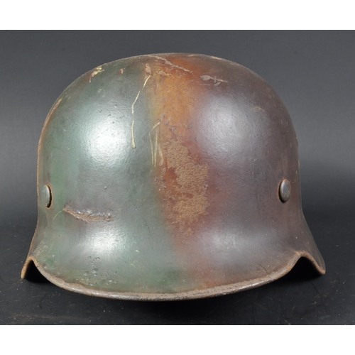 135 - A WWII Second World War Third Reich Nazi German M40 Stahlhelm steel combat helmet. Green and tan Nor... 