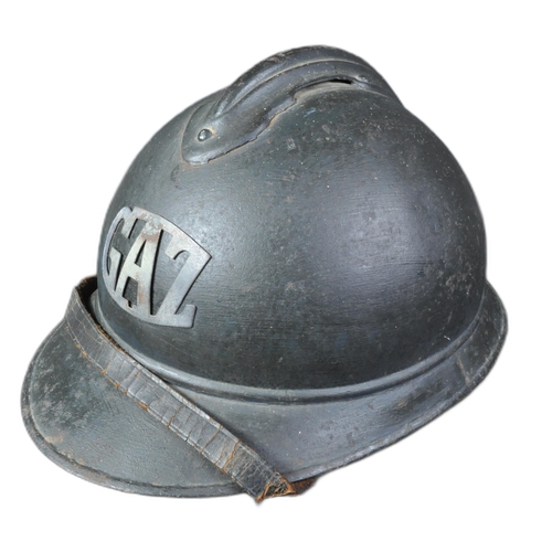 15 - A WWI First World War French M15 Adrian helmet with applied Gas Troop badge. The helmet of usual for... 