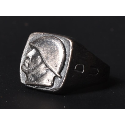 229 - A WWII Second World War Italian Fascist's ring depicting an embossed bust of a helmeted Benito Musso... 