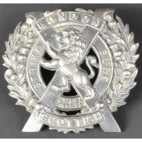 241 - A WWI First World War British London Scottish regiment silver cap badge. The badge depicting a Lion ... 