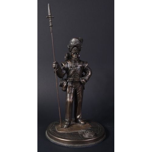 319 - A mid 20th Century bronzed figurine depicting a Royal Welsh Fusiliers Infantry soldier. The soldier ... 