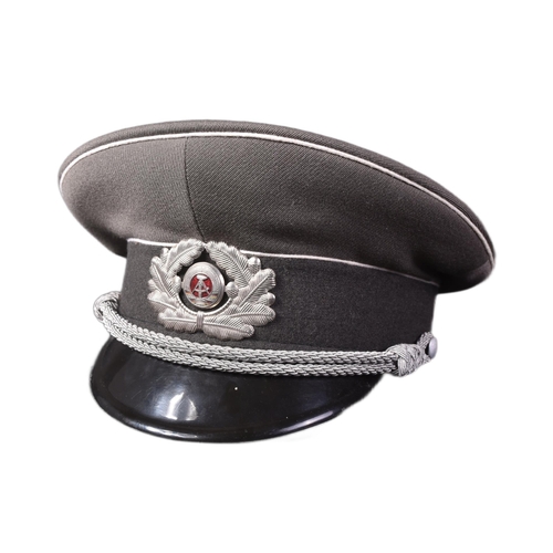 332 - A Cold War period East German Army / DDR Officers peaked uniform cap. The grey cap with white piping... 