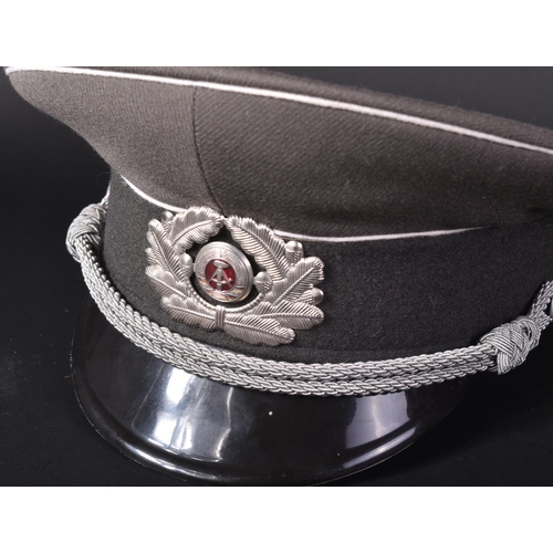 332 - A Cold War period East German Army / DDR Officers peaked uniform cap. The grey cap with white piping... 