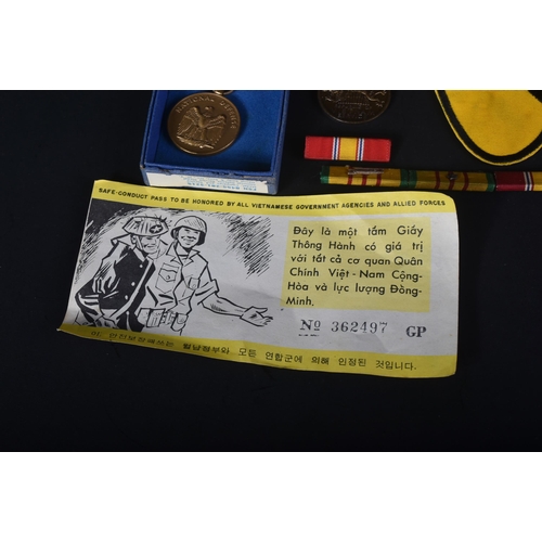 463 - Vietnam War - a collection of items relating to the conflict to include; a Tunnel Rat cloth uniform ... 