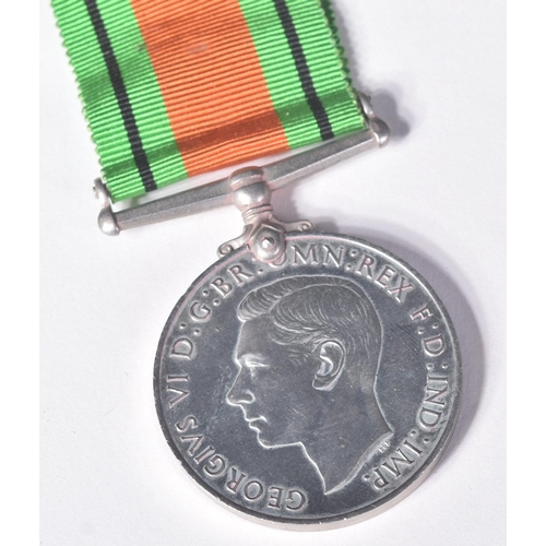 59 - An original WWII Second World War Defence Medal with original ribbon, awarded to one HJ. Day along w... 