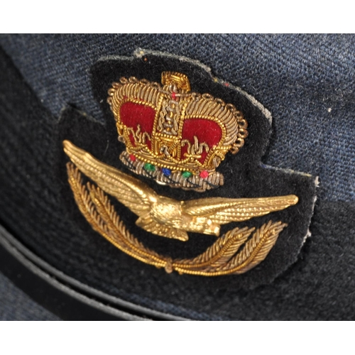 62 - A vintage 1950s WRAF Women's Royal Air Force peaked dress cap. The cap with metal eagle, crown and l... 