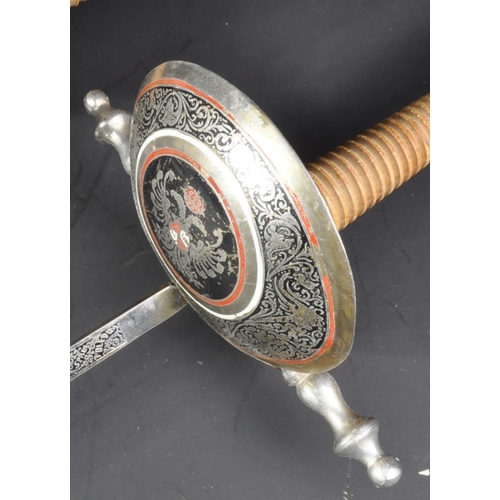 92 - A pair of 20th Century Spanish fencing sword foils with Toledo blades. The foils having urn shaped p... 