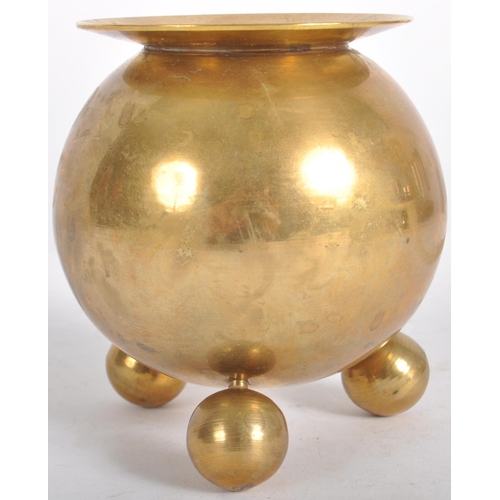 111 - A retro mid 20th Century designer brass candlestick holder having a lipped rim over a spherical body... 