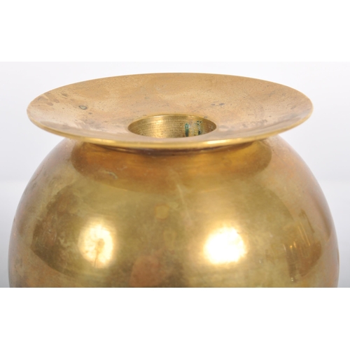 111 - A retro mid 20th Century designer brass candlestick holder having a lipped rim over a spherical body... 