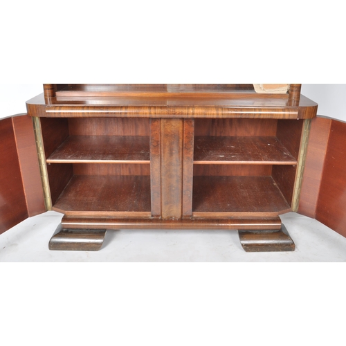 112 - A large vintage 20th Century Art Deco walnut veneer bookcase cabinet having a twin glass sliding doo... 