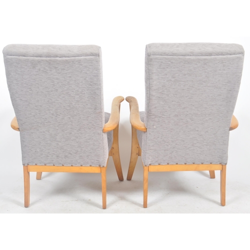 122 - Remploy - A matching pair of mid 20th Century beech framed armchairs / lounge chairs with each havin... 