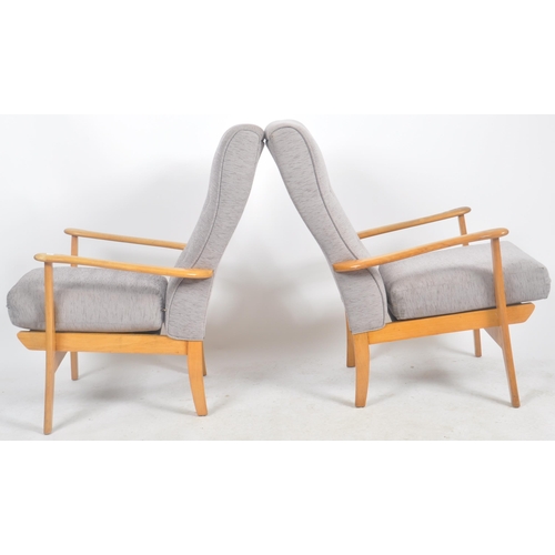 122 - Remploy - A matching pair of mid 20th Century beech framed armchairs / lounge chairs with each havin... 