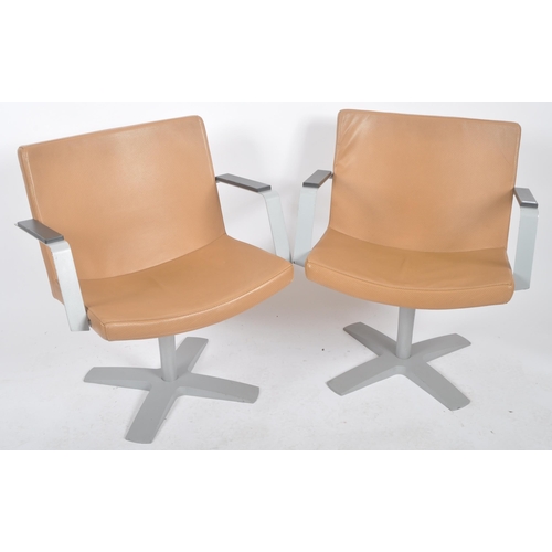 127 - Inno - A matching pair of 20th Century lounge chairs / swivel armchairs. Each having a padded seat a... 