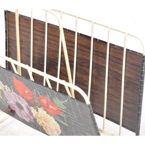 132 - A vintage mid Century 1950s magazine rack having tin panel sides with painted floral features. White... 