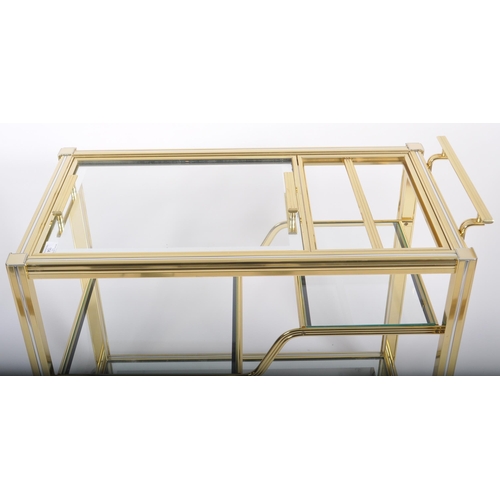 154 - A Contemporary designer brass effect three tier drink / cocktail trolley having a reeded framed with... 