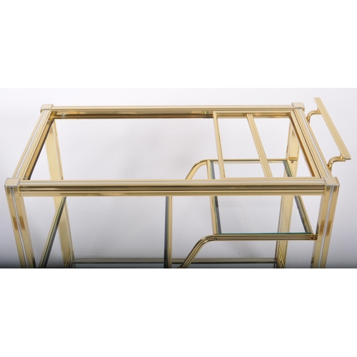 154 - A Contemporary designer brass effect three tier drink / cocktail trolley having a reeded framed with... 