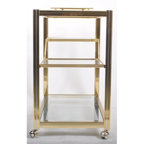 154 - A Contemporary designer brass effect three tier drink / cocktail trolley having a reeded framed with... 