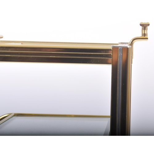 154 - A Contemporary designer brass effect three tier drink / cocktail trolley having a reeded framed with... 