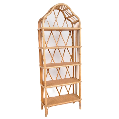 162 - A vintage mid 20th Century bamboo and cane bookcase having an arched top with woven shelves and open... 