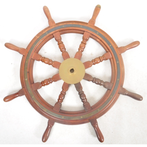 175 - A large 20th Century teak and brass ships wheel / helm of typical form with central brass mount and ... 