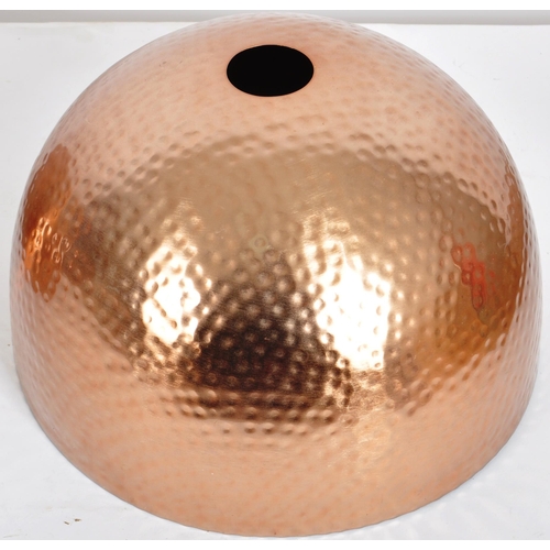 177 - A matching set of three Contemporary copper toned hand beaten ceiling light shades of domed form. Ea... 