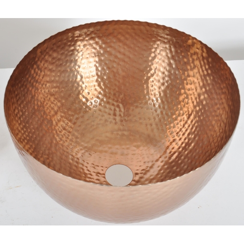 177 - A matching set of three Contemporary copper toned hand beaten ceiling light shades of domed form. Ea... 