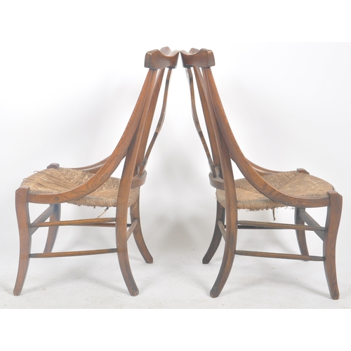 212 - A matching pair of late 19th Century Arts & Crafts oak chairs having yoke backrest tops with central... 