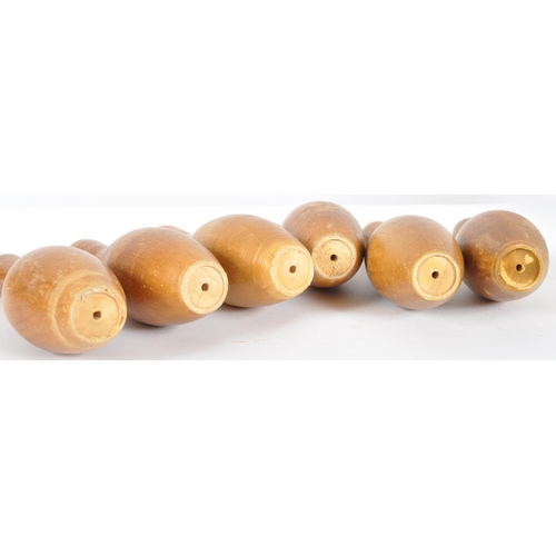 214 - A vintage retro mid 20th Century set of children's size wooden skittles comprising six pins and thre... 