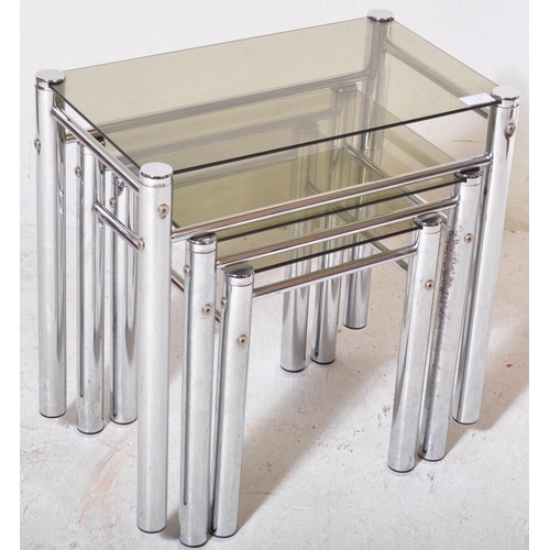 218 - A retro 20th Century 1970s chrome and smoked glass nest of tables. Each nesting table having thick c... 