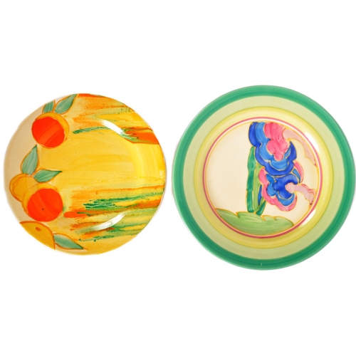 219 - Clarice Cliff - Two vintage 20th Century 1930s Art Deco hand painted plates. One plate decorated in ... 