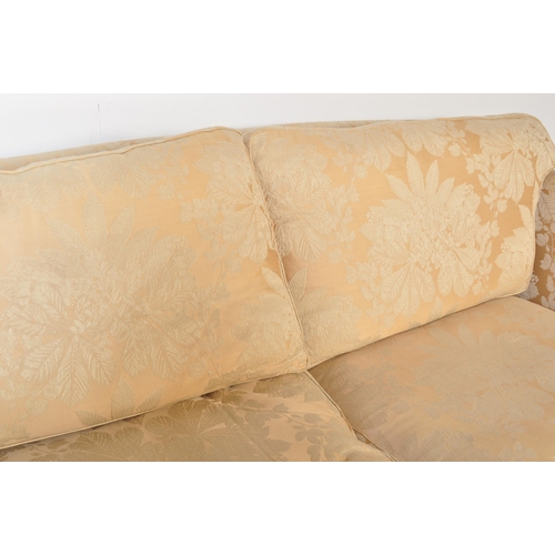 225 - Duresta - A 20th Century designer three seater sofa settee having rich golden floral upholstery with... 