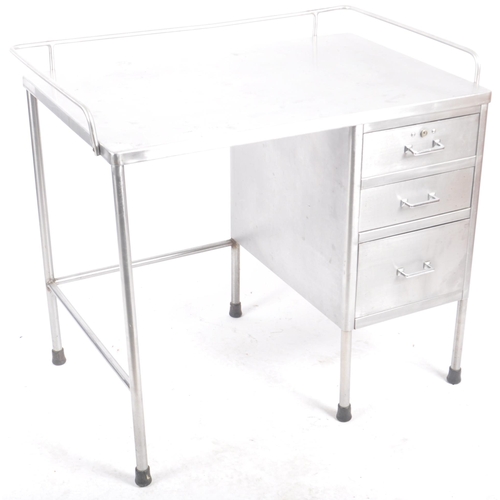 230 - A retro mid 20th Century stainless steel industrial / medical desk having a tubular gallery top with... 