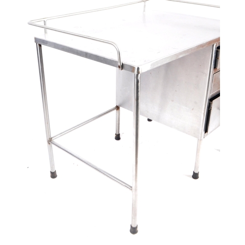 230 - A retro mid 20th Century stainless steel industrial / medical desk having a tubular gallery top with... 