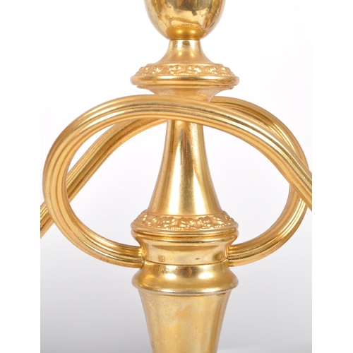 237 - A matching pair of late 20th Century Hollywood Regency gilt candlesticks with each having a central ... 