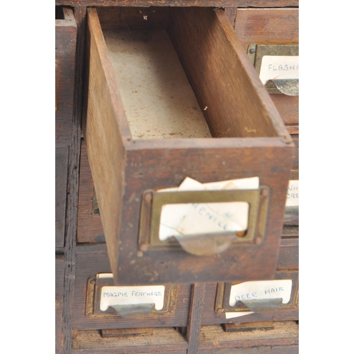 240 - An early 20th Century multi drawer pigeon hole cabinet / industrial filling chest having five rows o... 