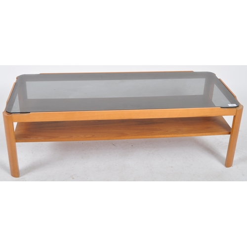 246 - Myers - A retro 20th Century 1970s teak wood coffee table / low table having an inset smoked glass t... 