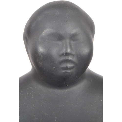 248 - A contemporary ceramic sculpture / figure in the form of a Sumo Wrestler finished in matte black and... 