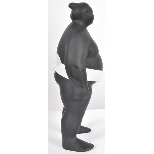 248 - A contemporary ceramic sculpture / figure in the form of a Sumo Wrestler finished in matte black and... 