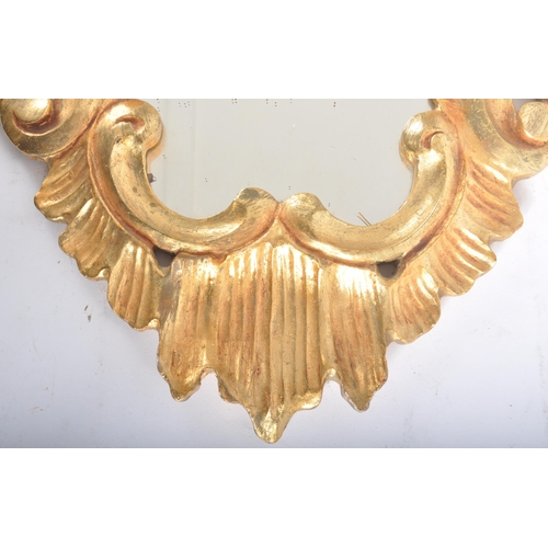 249 - A vintage mid Century Italian gilt framed mirror and wall mountable bracket. The mirror of decorativ... 