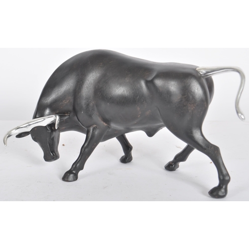 252 - A Contemporary cast resin figure / ornament in the form of a bull finished in black with silver tone... 