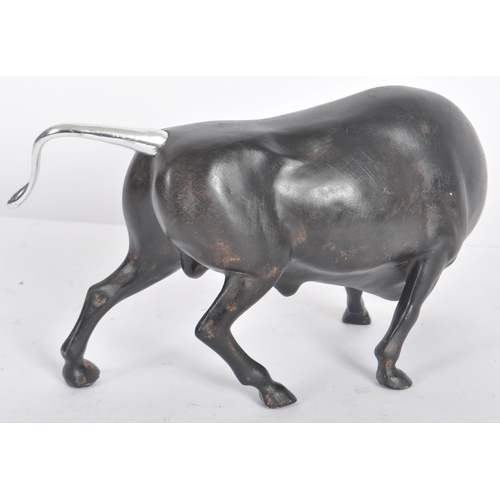 252 - A Contemporary cast resin figure / ornament in the form of a bull finished in black with silver tone... 