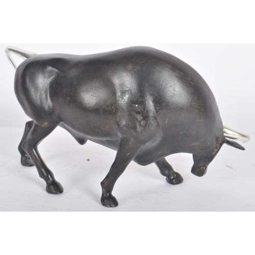 252 - A Contemporary cast resin figure / ornament in the form of a bull finished in black with silver tone... 