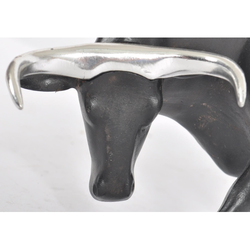 252 - A Contemporary cast resin figure / ornament in the form of a bull finished in black with silver tone... 