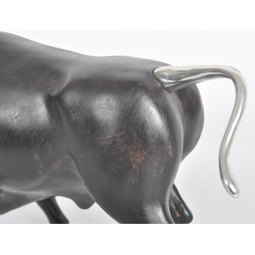 252 - A Contemporary cast resin figure / ornament in the form of a bull finished in black with silver tone... 