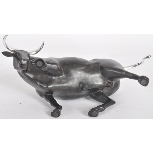 252 - A Contemporary cast resin figure / ornament in the form of a bull finished in black with silver tone... 