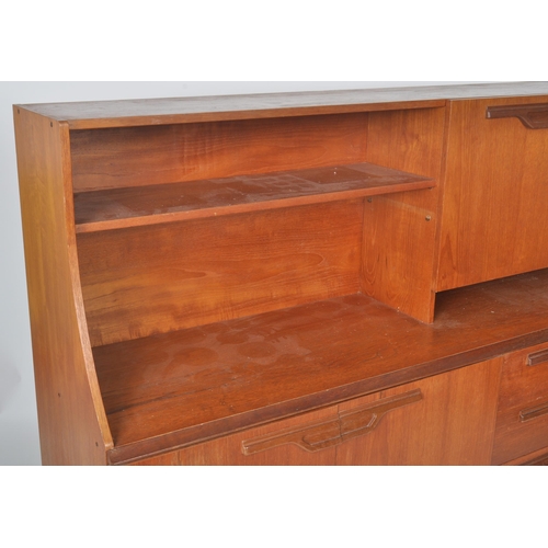 257 - Beautility - A retro vintage 1970s teak wood highboard / sideboard credenza having a shelved three q... 