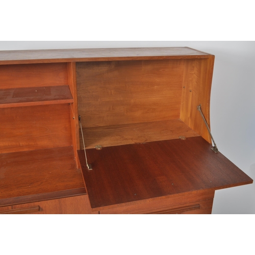 257 - Beautility - A retro vintage 1970s teak wood highboard / sideboard credenza having a shelved three q... 