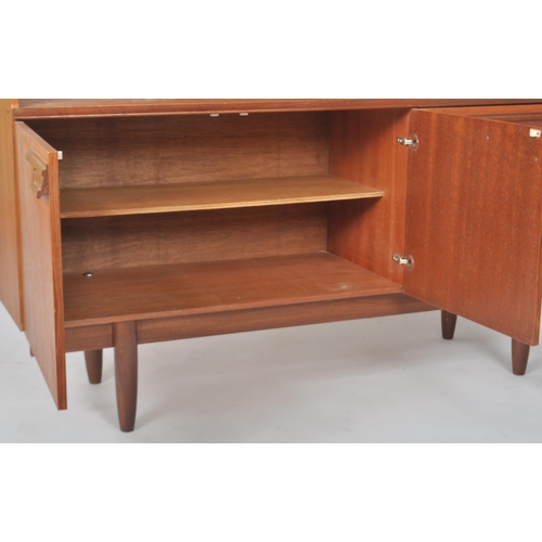 257 - Beautility - A retro vintage 1970s teak wood highboard / sideboard credenza having a shelved three q... 